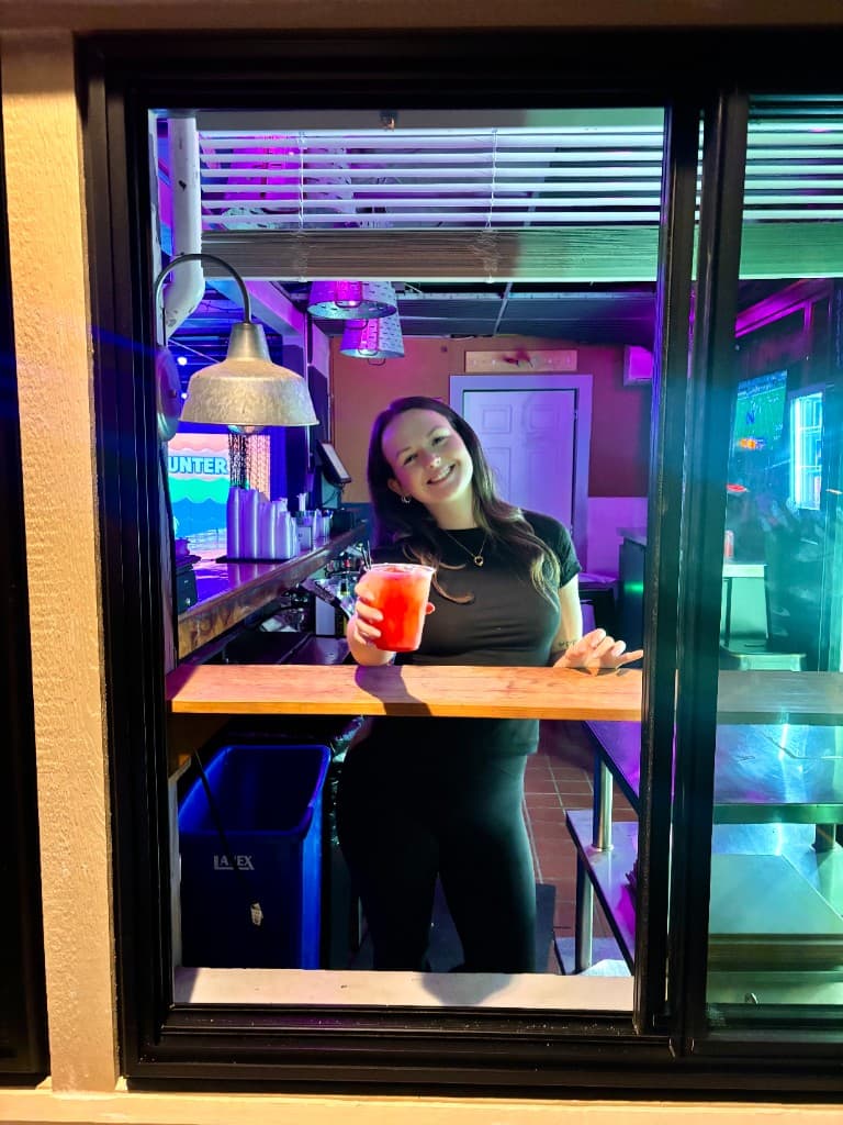 A bartender at Lil Rudy's Mountain Tapp holding a frozen drink